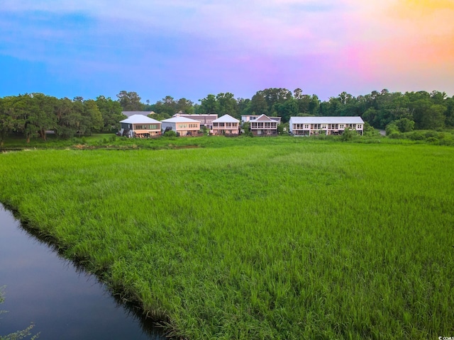 35 Red Skiff Ln Unit 35, Pawleys Island, SC 29585 - yard at dusk with a water view