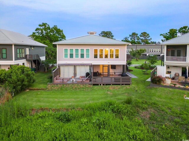 35 Red Skiff Ln Unit 35, Pawleys Island, SC 29585 - rear view of house featuring a deck and a lawn