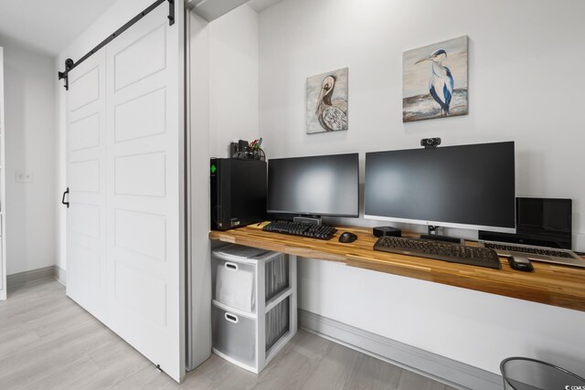 35 Red Skiff Ln Unit 35, Pawleys Island, SC 29585 - office area with a barn door, baseboards, and light wood-style flooring