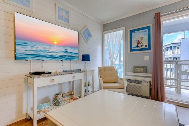 interior space featuring crown molding and an AC wall unit
