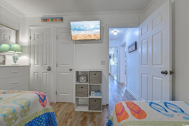 bedroom featuring wood finished floors and ornamental molding