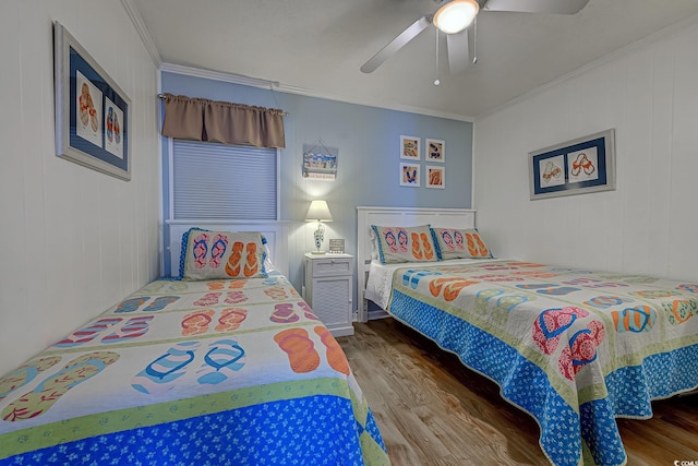 bedroom with crown molding, a ceiling fan, and wood finished floors