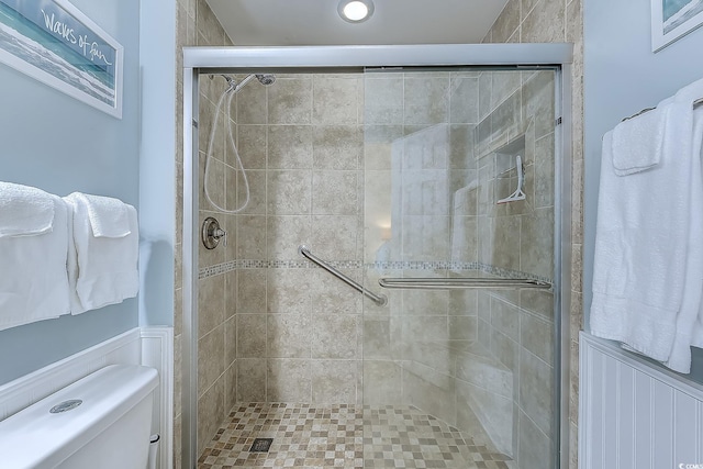 bathroom with toilet and a stall shower