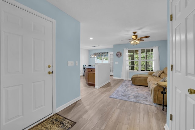 entrance foyer with ceiling fan, light wood-type flooring, recessed lighting, and baseboards