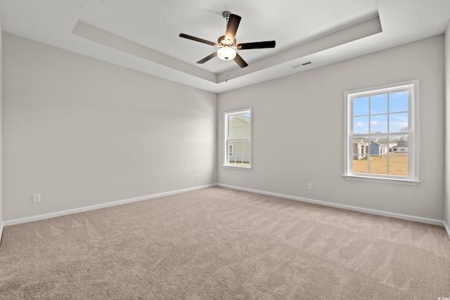 1513 Anne St, North Myrtle Beach, SC 29582 - carpeted empty room with a tray ceiling and a ceiling fan