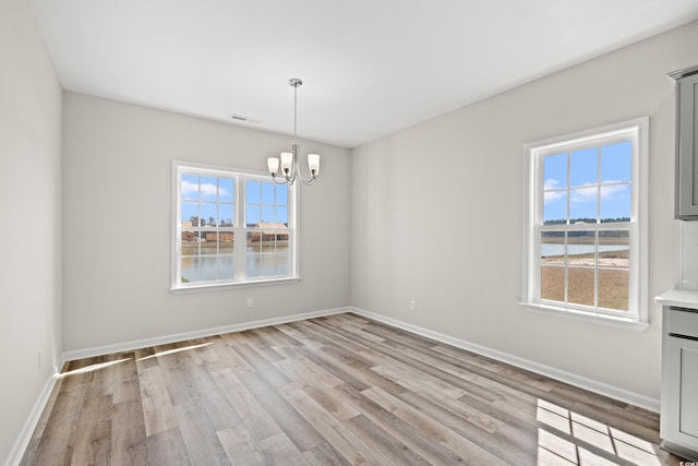 1513 Anne St, North Myrtle Beach, SC 29582 - unfurnished room featuring a chandelier, healthy amount of natural light, and light wood-type flooring