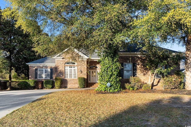 808 E Coast Ln, North Myrtle Beach, SC 29582 - view of front of home with brick siding and a front lawn