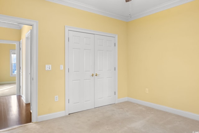 808 E Coast Ln, North Myrtle Beach, SC 29582 - unfurnished bedroom with ornamental molding, a closet, and carpet flooring
