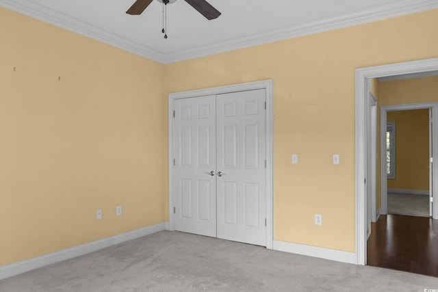 808 E Coast Ln, North Myrtle Beach, SC 29582 - unfurnished bedroom featuring carpet, a closet, ornamental molding, and ceiling fan
