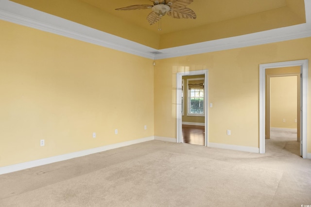 808 E Coast Ln, North Myrtle Beach, SC 29582 - empty room with a ceiling fan, light colored carpet, ornamental molding, and a raised ceiling