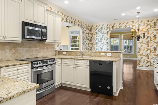 808 E Coast Ln, North Myrtle Beach, SC 29582 - kitchen featuring stainless steel appliances, wallpapered walls, dark wood-type flooring, ornamental molding, and plenty of natural light