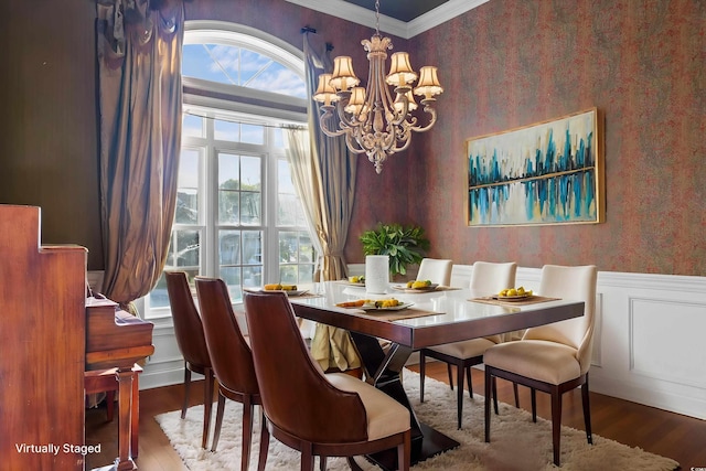 808 E Coast Ln, North Myrtle Beach, SC 29582 - dining room featuring wallpapered walls, wood finished floors, wainscoting, crown molding, and a chandelier