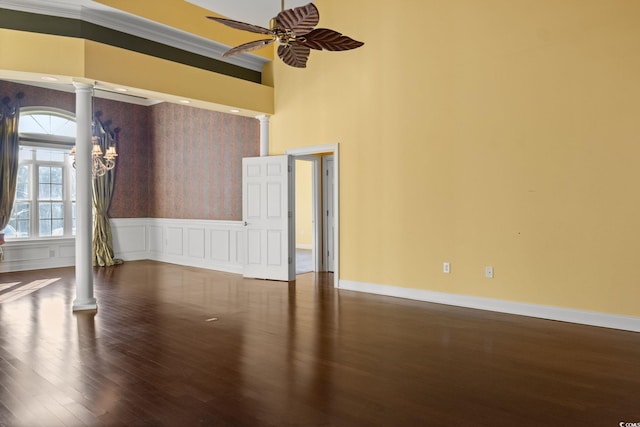 808 E Coast Ln, North Myrtle Beach, SC 29582 - spare room featuring decorative columns, ceiling fan, wood finished floors, and wainscoting