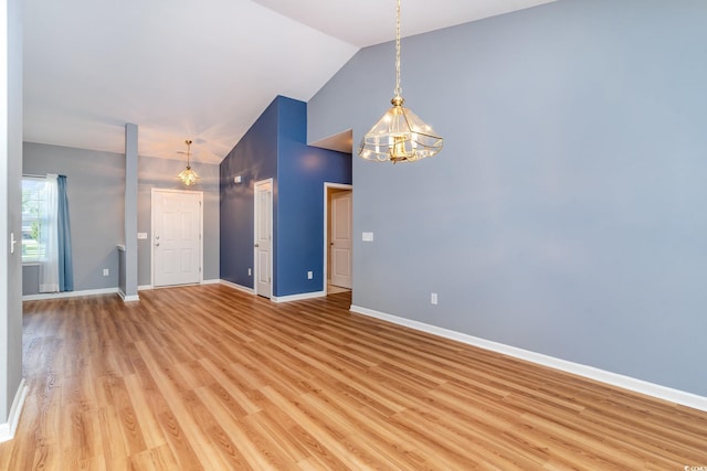 180 Oak Crest Cir, Longs, SC 29568 - unfurnished room with a chandelier, baseboards, light wood-style flooring, and high vaulted ceiling