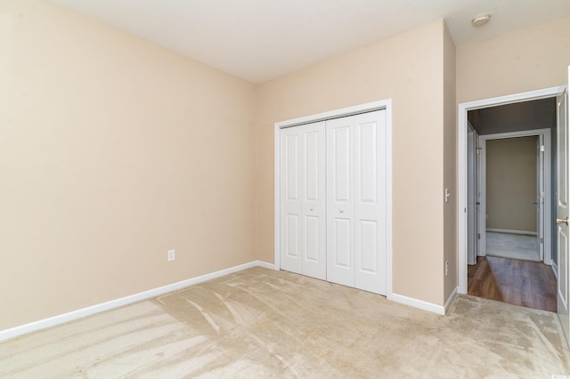 180 Oak Crest Cir, Longs, SC 29568 - unfurnished bedroom featuring light colored carpet, baseboards, and a closet