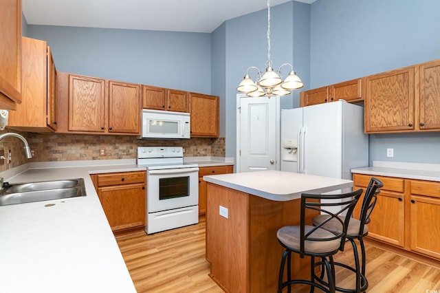 180 Oak Crest Cir, Longs, SC 29568 - kitchen featuring white appliances, a sink, a chandelier, light wood-type flooring, and a high ceiling