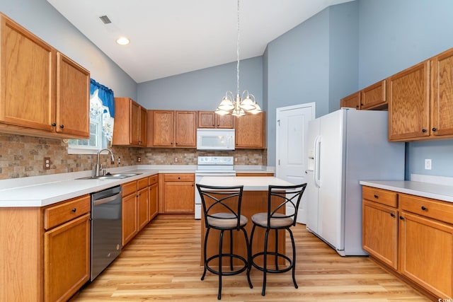 180 Oak Crest Cir, Longs, SC 29568 - kitchen with white appliances, a sink, backsplash, a chandelier, and light wood finished floors