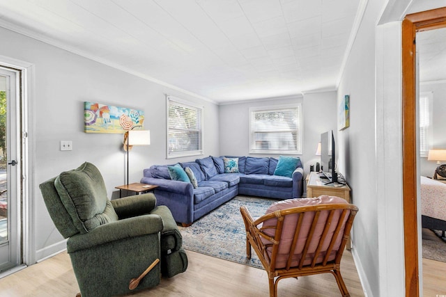 living area with crown molding and light wood-type flooring