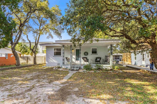 bungalow featuring fence and covered porch
