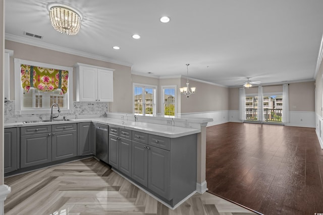 4891 Luster Leaf Cir Unit 301, Myrtle Beach, SC 29577 - kitchen featuring gray cabinetry, a chandelier, a peninsula, ceiling fan, and wainscoting