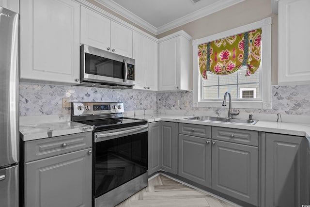 4891 Luster Leaf Cir Unit 301, Myrtle Beach, SC 29577 - kitchen with stainless steel appliances, gray cabinets, crown molding, light countertops, and decorative backsplash