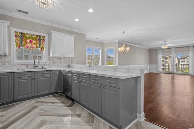 4891 Luster Leaf Cir Unit 301, Myrtle Beach, SC 29577 - kitchen featuring gray cabinets, stainless steel dishwasher, a peninsula, plenty of natural light, and wainscoting