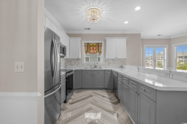 4891 Luster Leaf Cir Unit 301, Myrtle Beach, SC 29577 - kitchen featuring gray cabinetry, stainless steel appliances, a peninsula, white cabinets, and ornamental molding