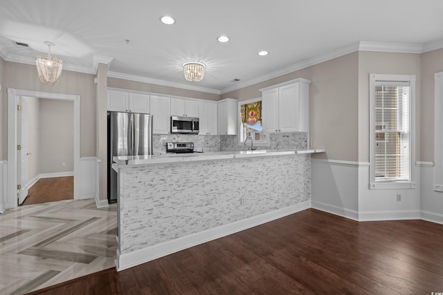 4891 Luster Leaf Cir Unit 301, Myrtle Beach, SC 29577 - kitchen featuring a chandelier, appliances with stainless steel finishes, light countertops, recessed lighting, and crown molding