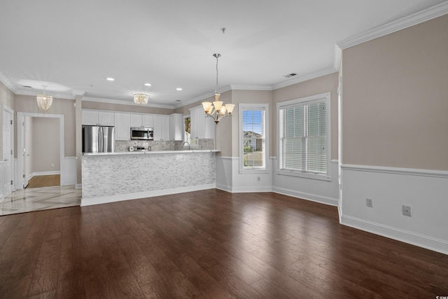 4891 Luster Leaf Cir Unit 301, Myrtle Beach, SC 29577 - unfurnished living room with a chandelier, hardwood / wood-style flooring, recessed lighting, and ornamental molding