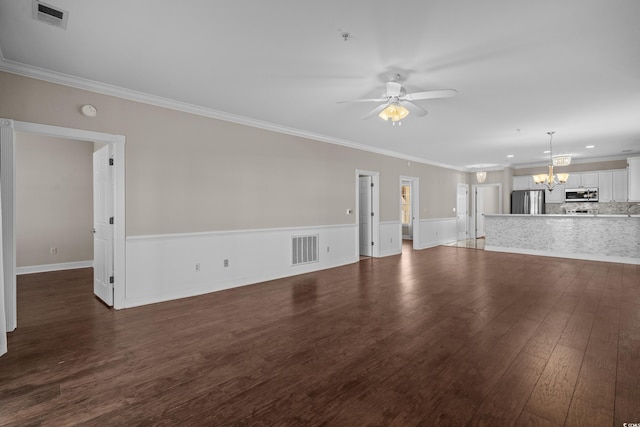 4891 Luster Leaf Cir Unit 301, Myrtle Beach, SC 29577 - unfurnished living room with a chandelier, a ceiling fan, dark wood finished floors, crown molding, and a wainscoted wall