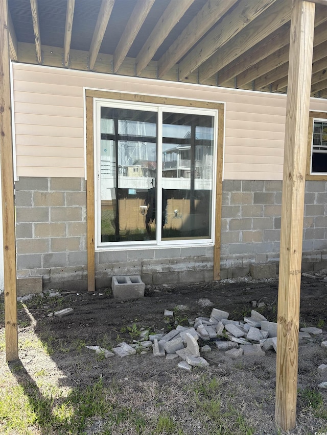 exterior space featuring concrete block wall