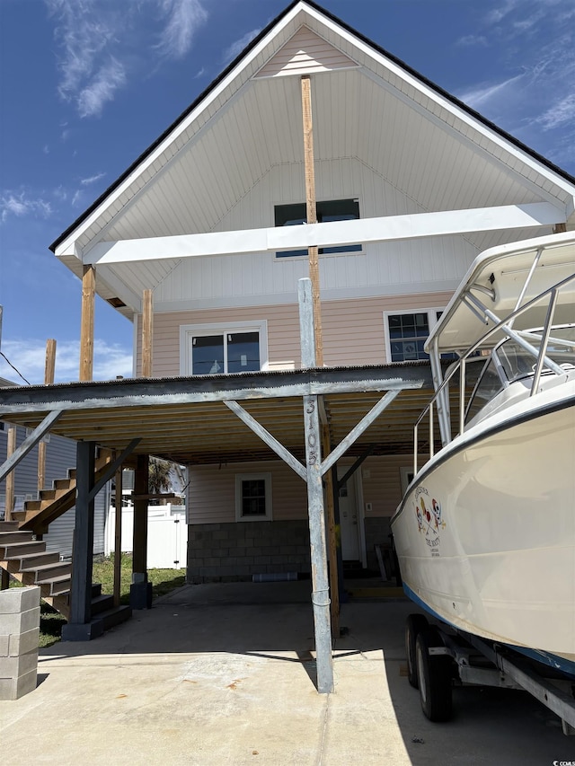 exterior space with a carport and stairway