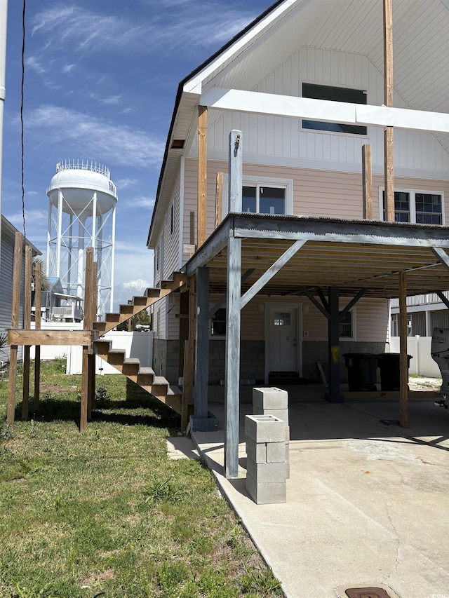 view of property exterior with a carport and a lawn