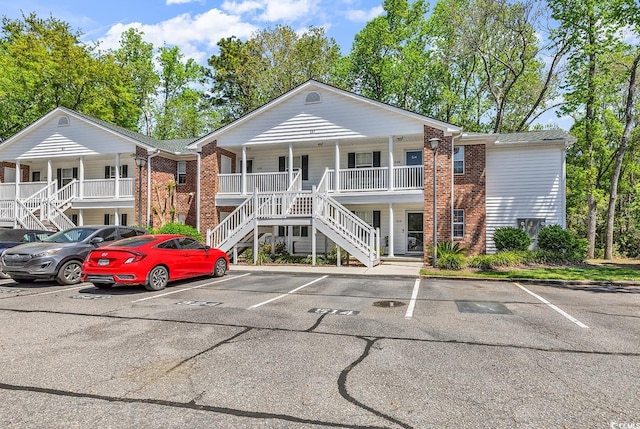 157 Egret Run Ln Unit 514, Pawleys Island, SC 29585 - view of building exterior with stairs and uncovered parking