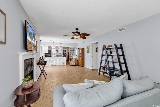 157 Egret Run Ln Unit 514, Pawleys Island, SC 29585 - living room featuring light tile patterned floors, ceiling fan, and a tile fireplace