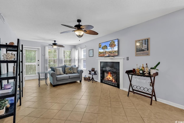 157 Egret Run Ln Unit 514, Pawleys Island, SC 29585 - living area with a glass covered fireplace, a ceiling fan, light tile patterned floors, and a textured ceiling