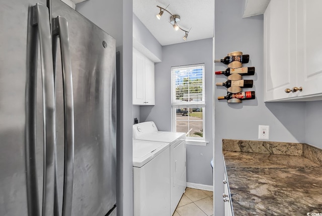 157 Egret Run Ln Unit 514, Pawleys Island, SC 29585 - washroom with cabinet space, washer and clothes dryer, and light tile patterned floors