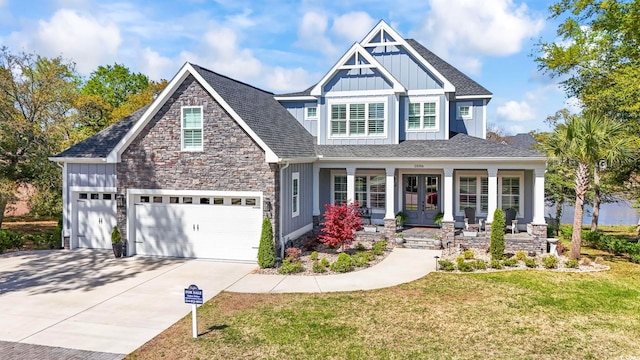 1006 Surf Pointe Dr, North Myrtle Beach, SC 29582 - craftsman-style home featuring board and batten siding, french doors, covered porch, driveway, and a front lawn