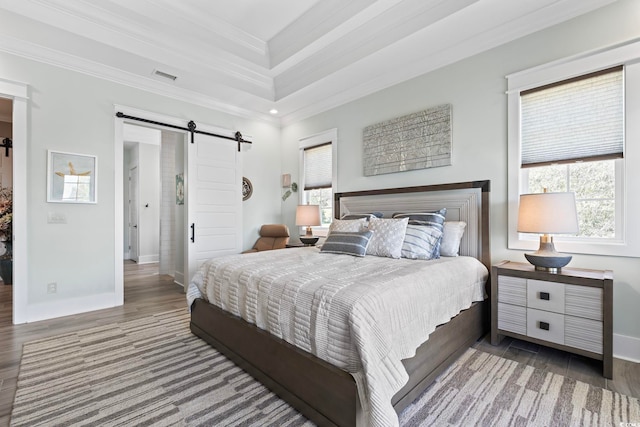 1006 Surf Pointe Dr, North Myrtle Beach, SC 29582 - bedroom with a barn door, crown molding, wood finished floors, and baseboards