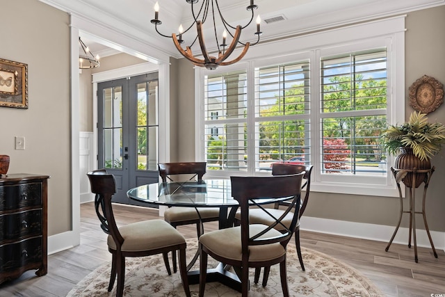 1006 Surf Pointe Dr, North Myrtle Beach, SC 29582 - dining space with french doors, ornamental molding, a chandelier, wood finished floors, and baseboards
