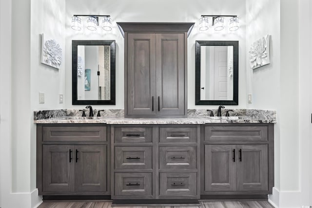 1006 Surf Pointe Dr, North Myrtle Beach, SC 29582 - bathroom featuring double vanity, baseboards, and wood finished floors