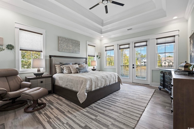 1006 Surf Pointe Dr, North Myrtle Beach, SC 29582 - bedroom featuring access to exterior, multiple windows, french doors, crown molding, and wood finished floors