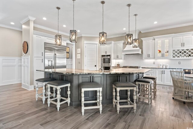 1006 Surf Pointe Dr, North Myrtle Beach, SC 29582 - kitchen with appliances with stainless steel finishes, white cabinetry, light wood finished floors, recessed lighting, and a large island