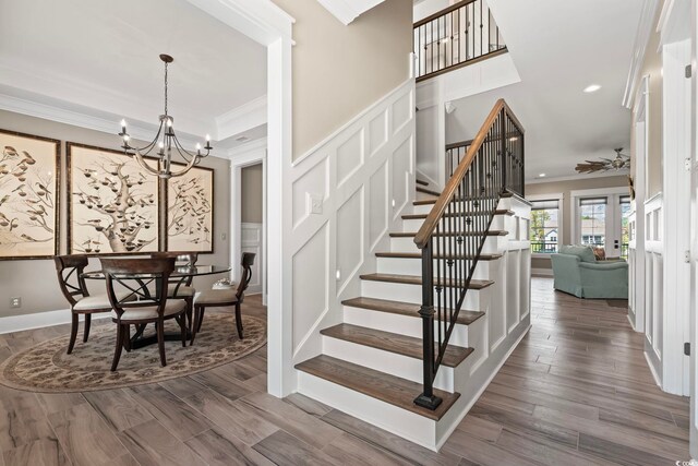 1006 Surf Pointe Dr, North Myrtle Beach, SC 29582 - stairs with ornamental molding, a chandelier, a ceiling fan, recessed lighting, and wood finished floors