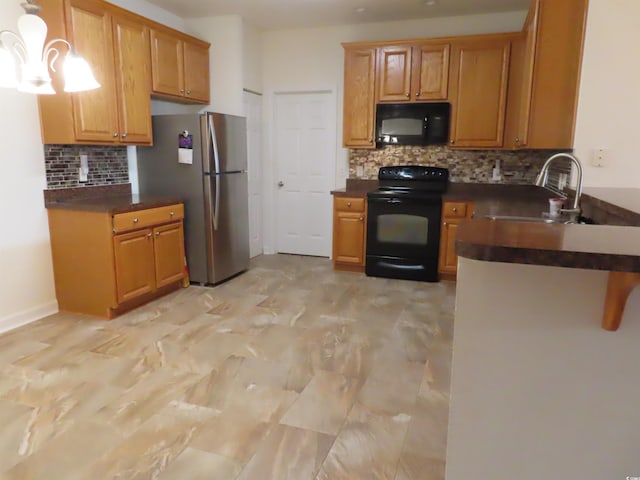 819 Brookline Dr, Myrtle Beach, SC 29579 - kitchen with black appliances, dark countertops, a sink, backsplash, and a peninsula