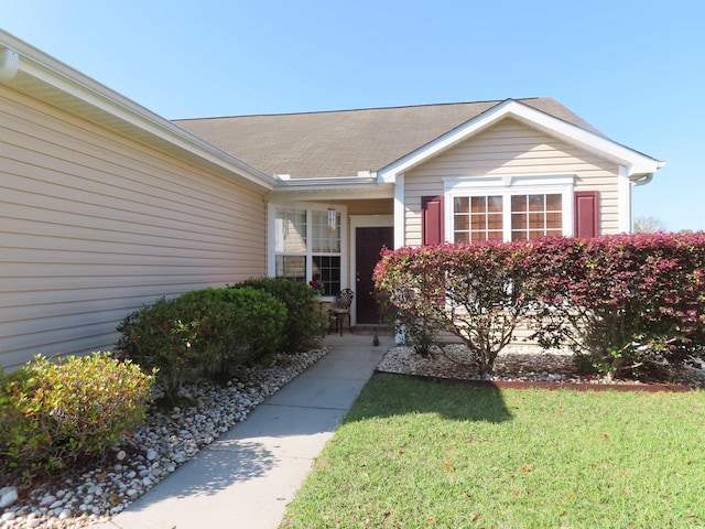 property entrance with a yard