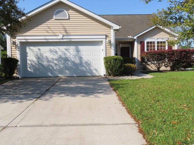 ranch-style home featuring a front yard, an attached garage, and driveway