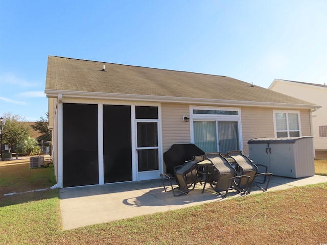 819 Brookline Dr, Myrtle Beach, SC 29579 - back of property featuring a patio, a shingled roof, central AC, and a yard