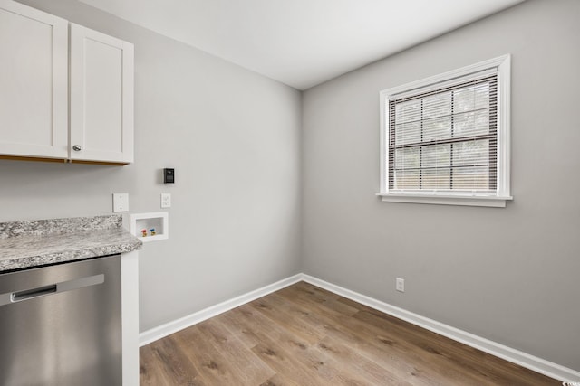 laundry room featuring wood finished floors, baseboards, hookup for a washing machine, and electric dryer hookup
