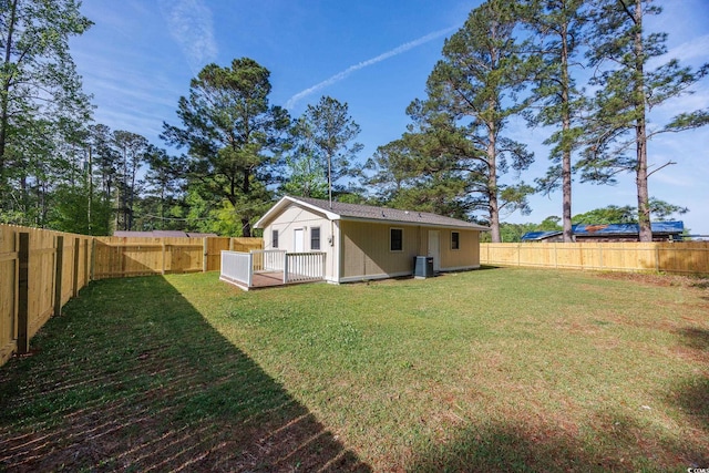 view of yard with an outbuilding, a fenced backyard, and central air condition unit